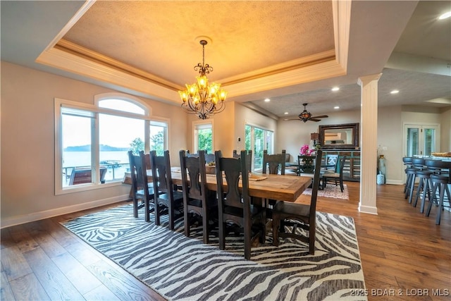1453 Grand View Dr, Porto Cima, MO 65079 - dining area with a raised ceiling, wood-type flooring, ornamental molding, a chandelier, and a ceiling fan