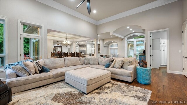 1453 Grand View Dr, Porto Cima, MO 65079 - living room featuring healthy amount of natural light, crown molding, a chandelier, dark wood-style floors, and recessed lighting
