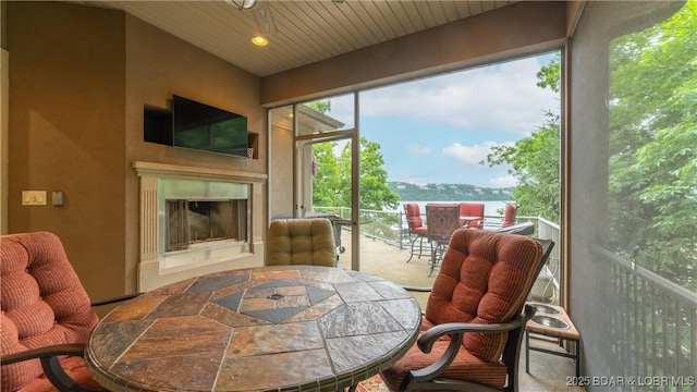 1453 Grand View Dr, Porto Cima, MO 65079 - carpeted dining area featuring a glass covered fireplace