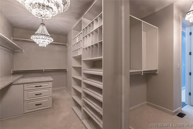 1453 Grand View Dr, Porto Cima, MO 65079 - walk in closet featuring a chandelier and carpet floors