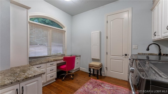 1453 Grand View Dr, Porto Cima, MO 65079 - home office featuring dark wood-style flooring, washer and clothes dryer, and built in study area