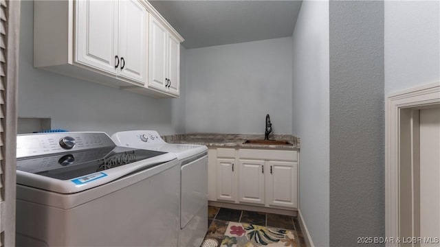 1453 Grand View Dr, Porto Cima, MO 65079 - laundry area with washer and clothes dryer, cabinet space, and dark stone finish flooring