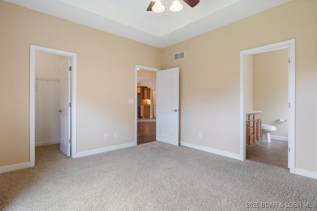 267 Cornett Branch Rd, Four Seasons, MO 65049 - unfurnished bedroom featuring carpet floors, a spacious closet, a closet, ensuite bath, and a ceiling fan