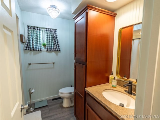 2439 Mohawk Ln, Osage Beach, MO 65065 - full bathroom featuring wood finished floors, vanity, and a chandelier