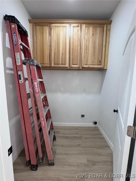 1378 Full Gallop Ln, Roach, MO 65787 - laundry room with light wood-style flooring and baseboards
