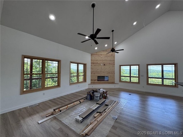 1378 Full Gallop Ln, Roach, MO 65787 - unfurnished living room featuring high vaulted ceiling, a ceiling fan, plenty of natural light, wood finished floors, and recessed lighting