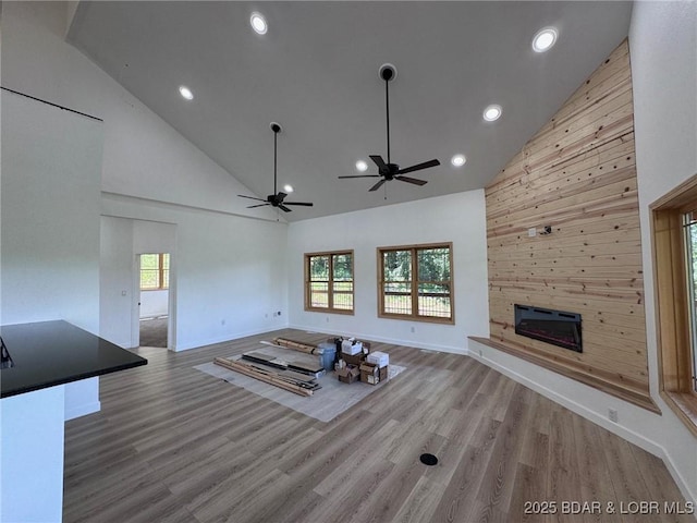 1378 Full Gallop Ln, Roach, MO 65787 - unfurnished living room with high vaulted ceiling, a ceiling fan, a large fireplace, wood finished floors, and recessed lighting
