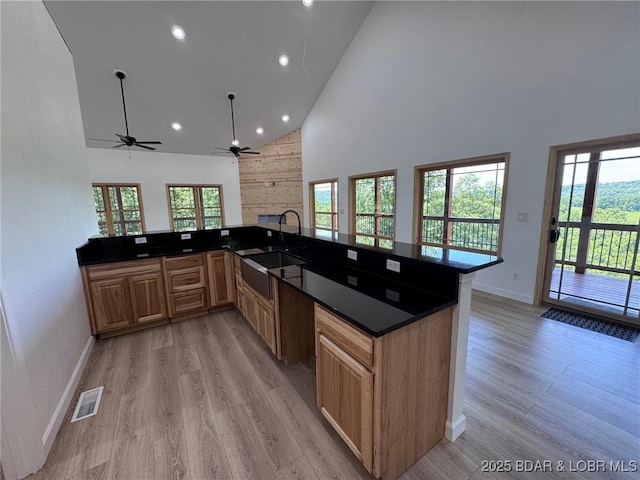 1378 Full Gallop Ln, Roach, MO 65787 - kitchen with high vaulted ceiling, ceiling fan, light wood-type flooring, dark countertops, and recessed lighting