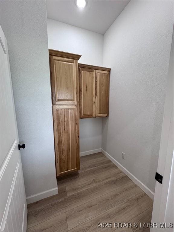 1378 Full Gallop Ln, Roach, MO 65787 - laundry room featuring light wood-style flooring and baseboards