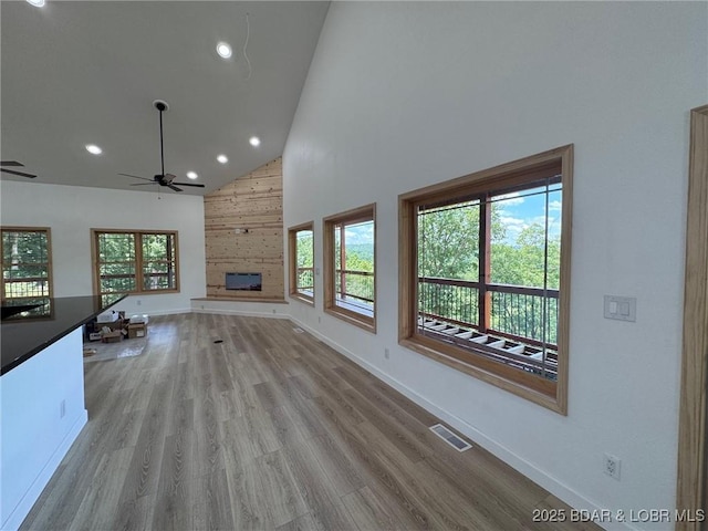 1378 Full Gallop Ln, Roach, MO 65787 - unfurnished living room with high vaulted ceiling, ceiling fan, recessed lighting, a fireplace, and wood finished floors