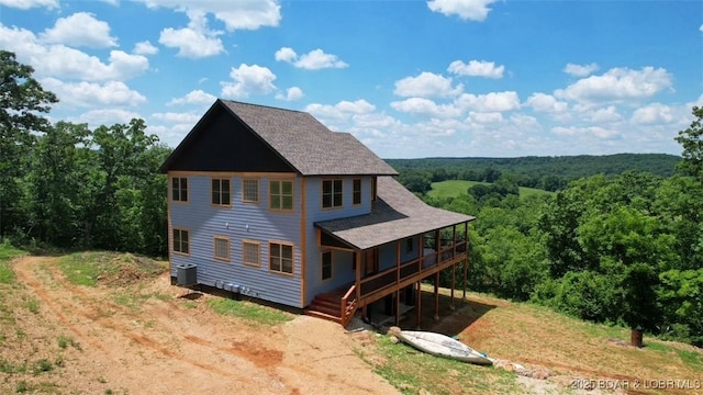 1378 Full Gallop Ln, Roach, MO 65787 - back of property with a forest view, a wooden deck, and a shingled roof