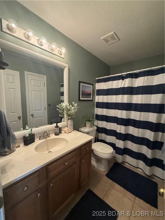 1720 Lakeview Dr, Chillicothe, MO 64601 - bathroom featuring tile patterned floors, vanity, and a textured ceiling