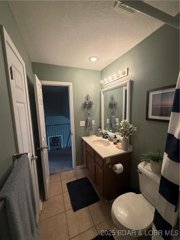 1720 Lakeview Dr, Chillicothe, MO 64601 - bathroom featuring vanity, tile patterned floors, and a textured ceiling