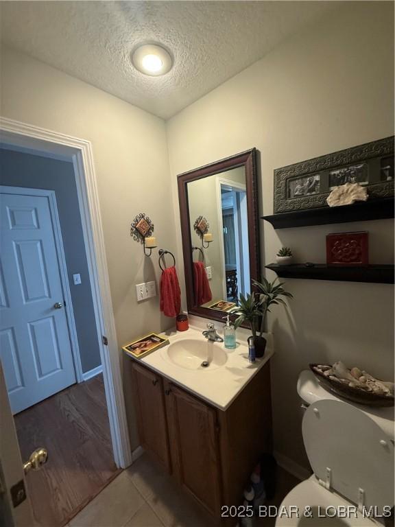 1720 Lakeview Dr, Chillicothe, MO 64601 - bathroom with a textured ceiling, vanity, and tile patterned floors