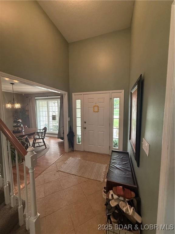 1720 Lakeview Dr, Chillicothe, MO 64601 - entrance foyer with a towering ceiling, tile patterned floors, and a chandelier