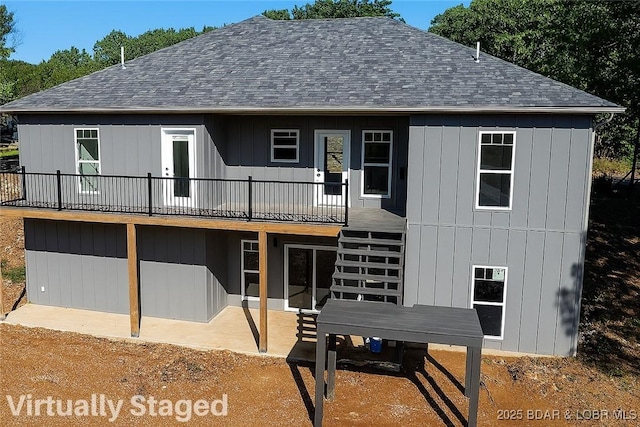 25 Sam Dr, Kaiser, MO 65047 - back of property with a shingled roof, a wooden deck, stairs, and a patio area
