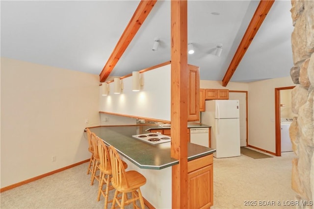 290 Fawn Meadows Dr, Linn Creek, MO 65052 - kitchen featuring white appliances, dark countertops, light colored carpet, washer / dryer, and a breakfast bar