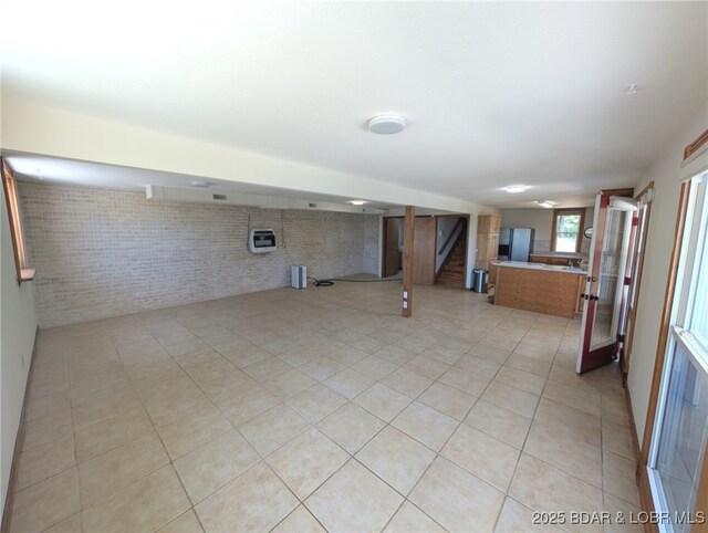 742 Pappys Pt, Sunrise Beach, MO 65079 - basement featuring stairway, brick wall, and light tile patterned floors