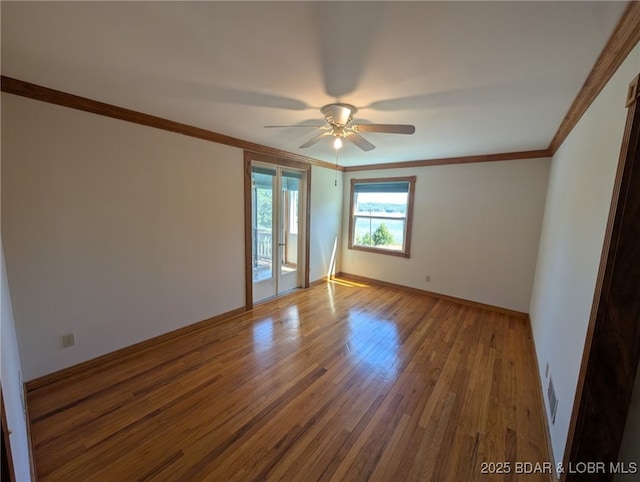 742 Pappys Pt, Sunrise Beach, MO 65079 - empty room featuring ornamental molding, wood finished floors, and ceiling fan
