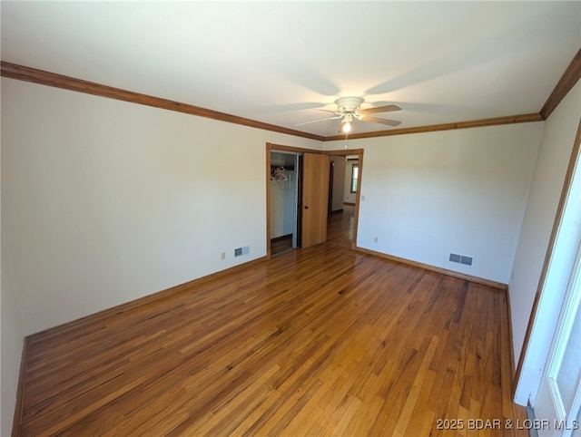 742 Pappys Pt, Sunrise Beach, MO 65079 - unfurnished room with hardwood / wood-style floors, a ceiling fan, and ornamental molding