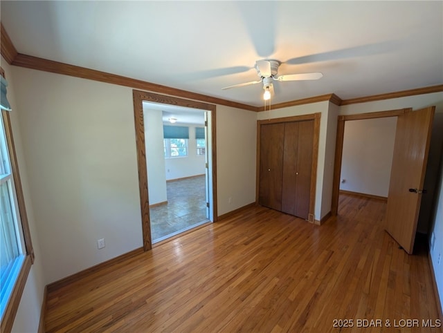 742 Pappys Pt, Sunrise Beach, MO 65079 - unfurnished bedroom with a closet, light wood-style flooring, crown molding, and ceiling fan