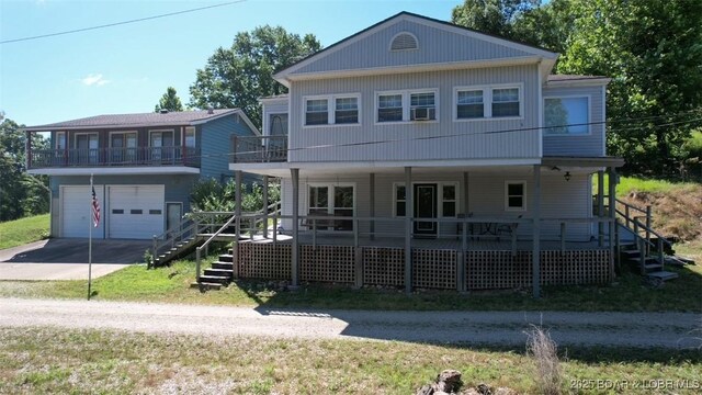 742 Pappys Pt, Sunrise Beach, MO 65079 - view of front of home with driveway, an attached garage, stairway, and covered porch