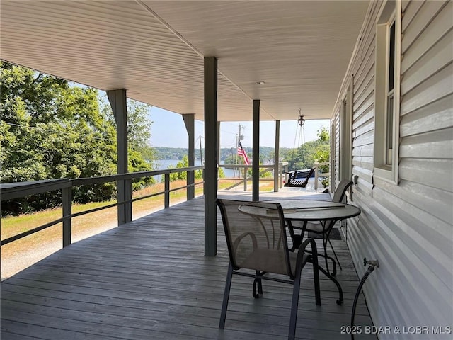 742 Pappys Pt, Sunrise Beach, MO 65079 - wooden deck with a water view and outdoor dining area