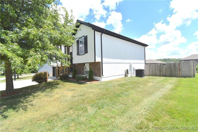 1207 SW 9th St, Oak Grove, MO 64075 - view of side of property featuring a central AC unit and brick siding