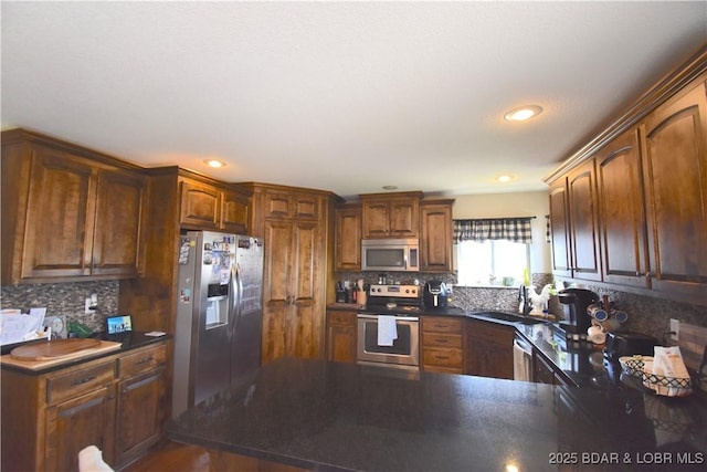 1207 SW 9th St, Oak Grove, MO 64075 - kitchen featuring stainless steel appliances, dark countertops, tasteful backsplash, a peninsula, and recessed lighting