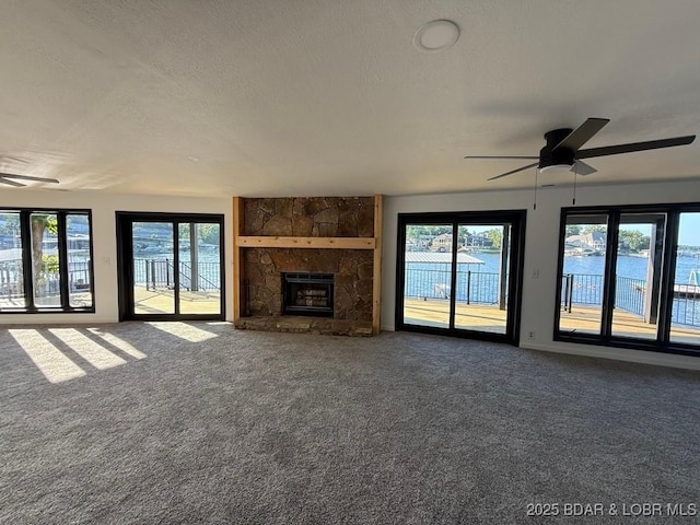5185 Lois Ln, Osage Beach, MO 65065 - unfurnished living room with ceiling fan, carpet flooring, healthy amount of natural light, and a textured ceiling