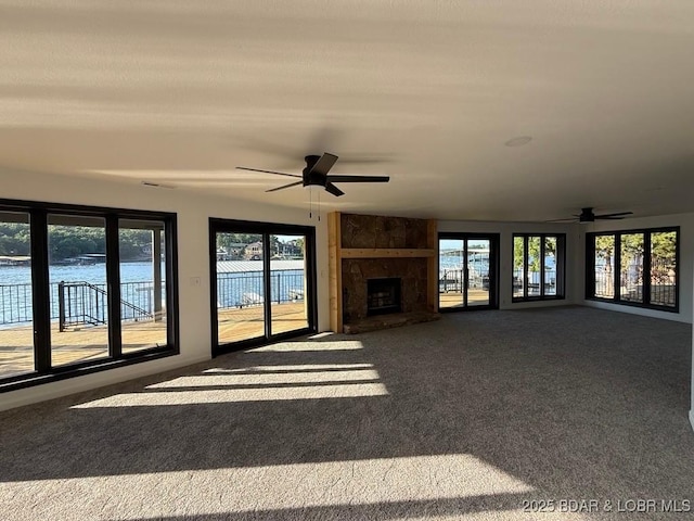 5185 Lois Ln, Osage Beach, MO 65065 - unfurnished living room with a ceiling fan, carpet, and a large fireplace