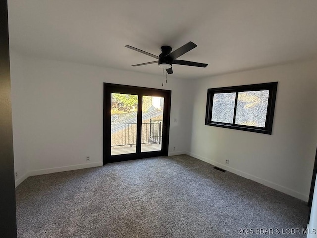 5185 Lois Ln, Osage Beach, MO 65065 - carpeted empty room featuring plenty of natural light and a ceiling fan