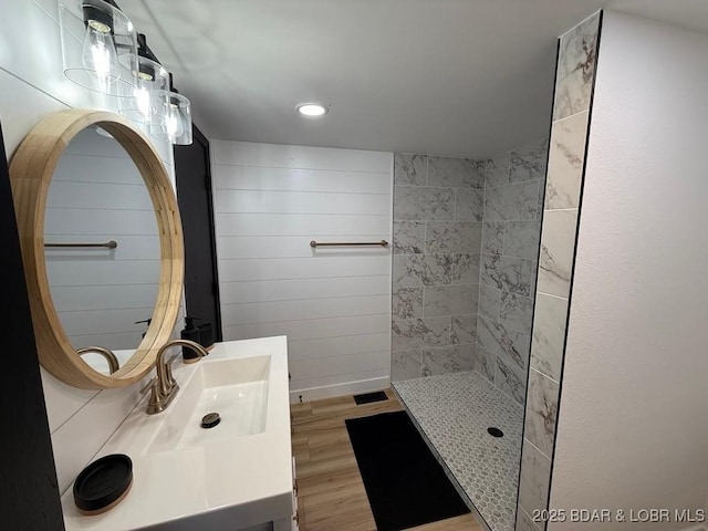5185 Lois Ln, Osage Beach, MO 65065 - bathroom with walk in shower, wood finished floors, and vanity