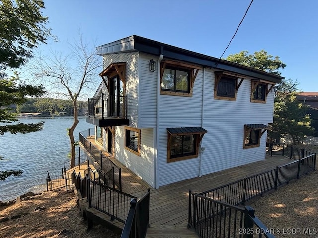 5185 Lois Ln, Osage Beach, MO 65065 - view of property exterior with a deck with water view and a balcony