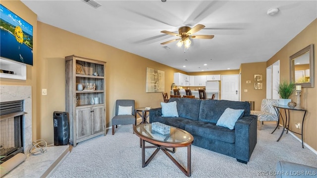 1481 Ledges Dr Unit B14, Osage Beach, MO 65065 - living area with a ceiling fan, light colored carpet, and a fireplace
