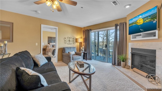1481 Ledges Dr Unit B14, Osage Beach, MO 65065 - living area featuring carpet, a ceiling fan, and a high end fireplace