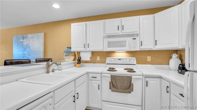1481 Ledges Dr Unit B14, Osage Beach, MO 65065 - kitchen featuring white appliances, white cabinets, recessed lighting, light countertops, and a peninsula