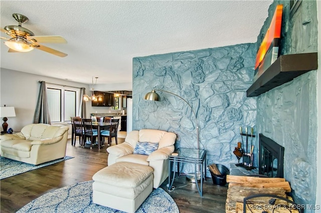 889 Malibu Rd Unit 63, Osage Beach, MO 65049 - living room with a ceiling fan, wood finished floors, a fireplace, and a textured ceiling