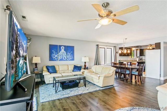 889 Malibu Rd Unit 63, Osage Beach, MO 65049 - living room with wood finished floors, ceiling fan, and a chandelier
