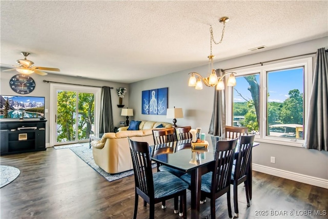 889 Malibu Rd Unit 63, Osage Beach, MO 65049 - dining space with a chandelier, a textured ceiling, dark wood-style flooring, and a ceiling fan