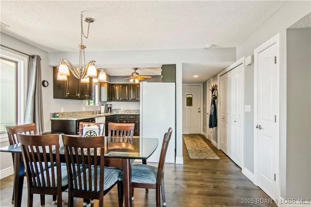 889 Malibu Rd Unit 63, Osage Beach, MO 65049 - dining space with a textured ceiling, dark wood-style floors, a chandelier, and ceiling fan