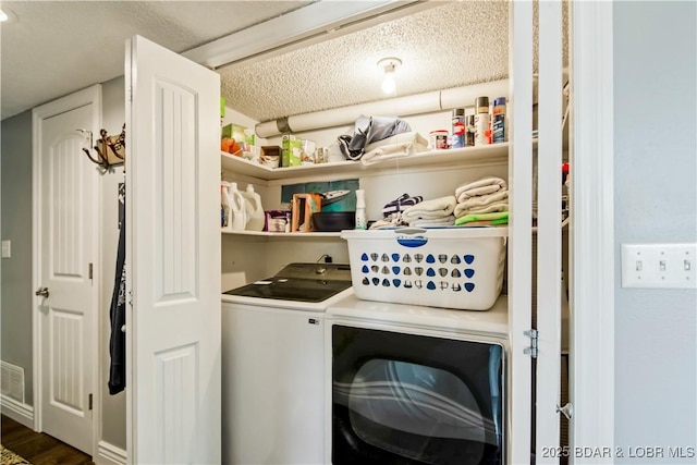 889 Malibu Rd Unit 63, Osage Beach, MO 65049 - laundry area featuring washing machine and dryer, dark wood-style floors, and a textured ceiling
