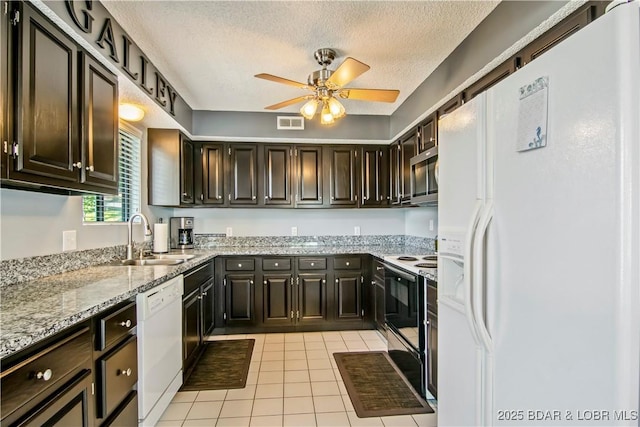 889 Malibu Rd Unit 63, Osage Beach, MO 65049 - kitchen with white appliances, ceiling fan, light tile patterned flooring, light stone countertops, and a textured ceiling