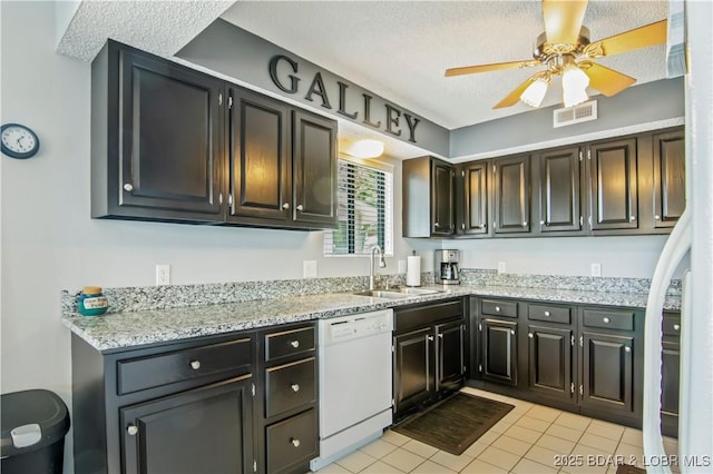 889 Malibu Rd Unit 63, Osage Beach, MO 65049 - kitchen with white dishwasher, ceiling fan, light tile patterned floors, light stone counters, and a textured ceiling