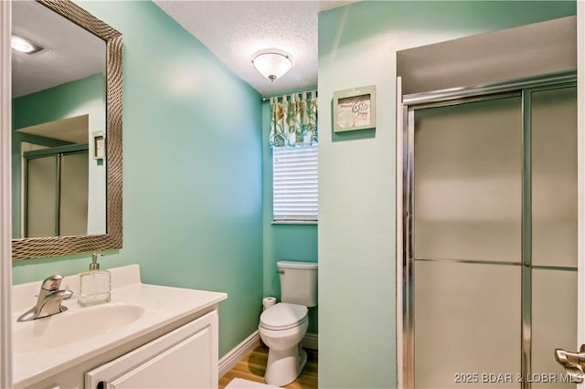 889 Malibu Rd Unit 63, Osage Beach, MO 65049 - bathroom featuring a shower stall, vanity, and a textured ceiling