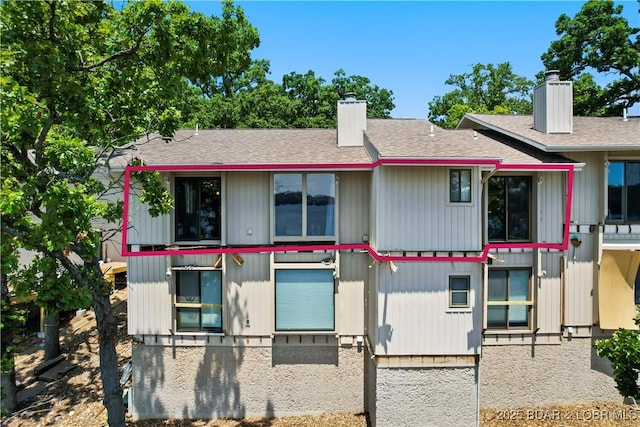 889 Malibu Rd Unit 63, Osage Beach, MO 65049 - view of front of house with a chimney and a shingled roof