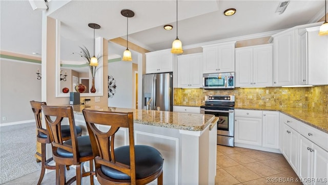 895 Summer Place Dr Unit 3A, Camdenton, MO 65020 - kitchen with stainless steel appliances, a kitchen breakfast bar, white cabinets, light stone counters, and recessed lighting