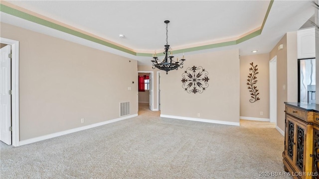 895 Summer Place Dr Unit 3A, Camdenton, MO 65020 - unfurnished living room featuring a chandelier, a raised ceiling, and carpet flooring
