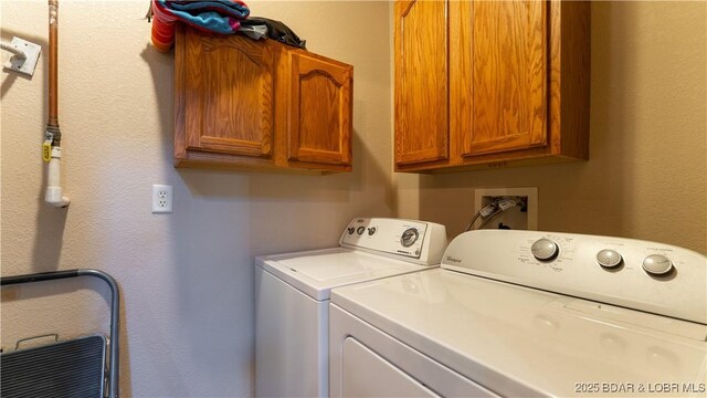 1126 Buckingham Dr, Camdenton, MO 65020 - laundry area featuring cabinet space and washing machine and clothes dryer