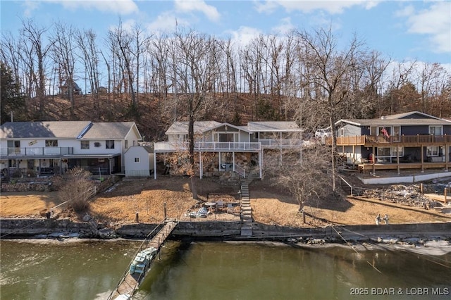 740 Twin Valley Loop, Linn Creek, MO 65052 - back of house featuring stairway, a deck with water view, and a residential view